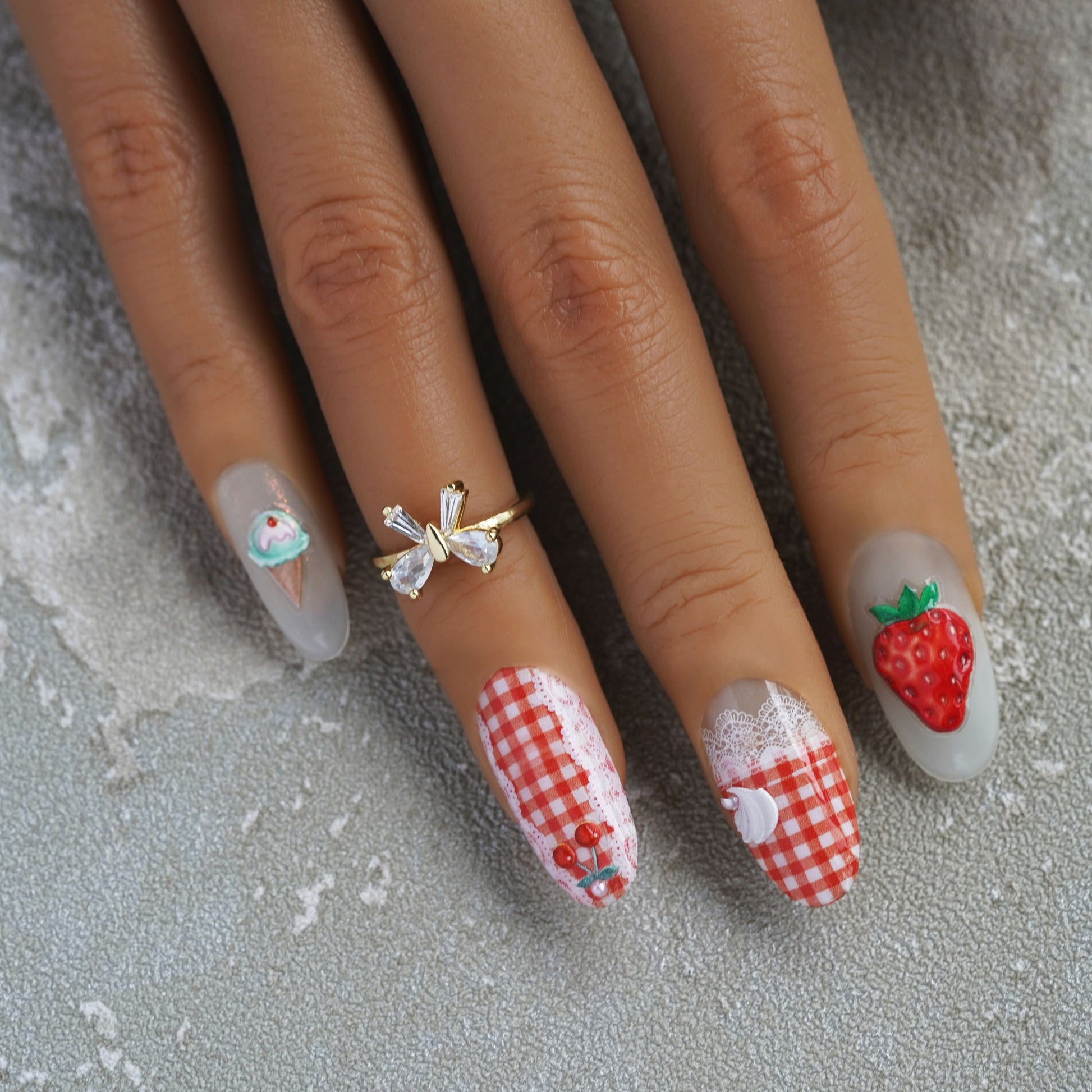short round press on nails on model fingers strawberry sticker